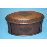 An oval shaped wooden cigarette box