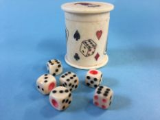 A small early 20th century bone container decorated with dice and playing cards, containing six
