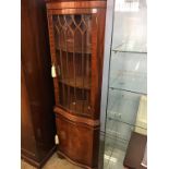 A reproduction corner cabinet