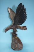 A carved wooden Eagle on stand and a carved wood Wolf's head (2)