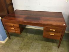 A rosewood desk with five drawers to the front, supported on turned legs, 152cm wide x 75cm deep