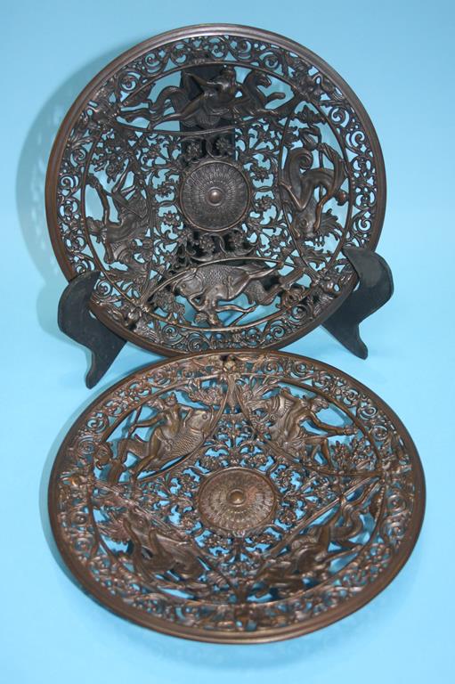 A pair of decorative Coalbrookdale style pierced plates, decorated with mythical figures