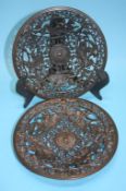 A pair of decorative Coalbrookdale style pierced plates, decorated with mythical figures