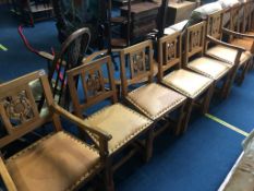 A set of six Squirrel Man oak dining chairs, comprising two carvers and four singles, the back set