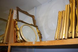 A shelf of pictures and mirrors