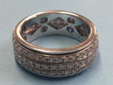 A Brooks and Bentley 9ct white gold ring, set with three rows of diamonds. Total weight 7.9 grams