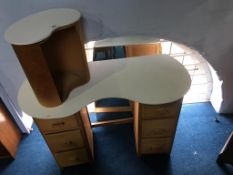 A kidney shaped dressing table, mirror and stool