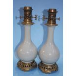 A pair of Chinese Celadon porcelain table oil lamps, with brass mounts. 40cm high