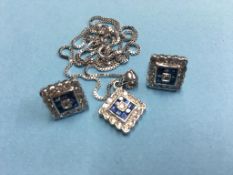 An 18ct white gold diamond and sapphire pendant and chain and a pair of matching earrings. Total