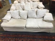 A large four seater cream settee (all covers removable and washable)