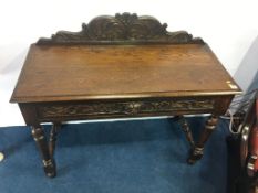 A oak side table with carved single drawer, 107cm wide