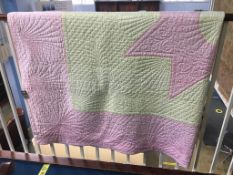 A good white Durham quilt with a pink star, yellow and pink outer border