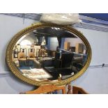 Gilt oval mirror, 96cm wide