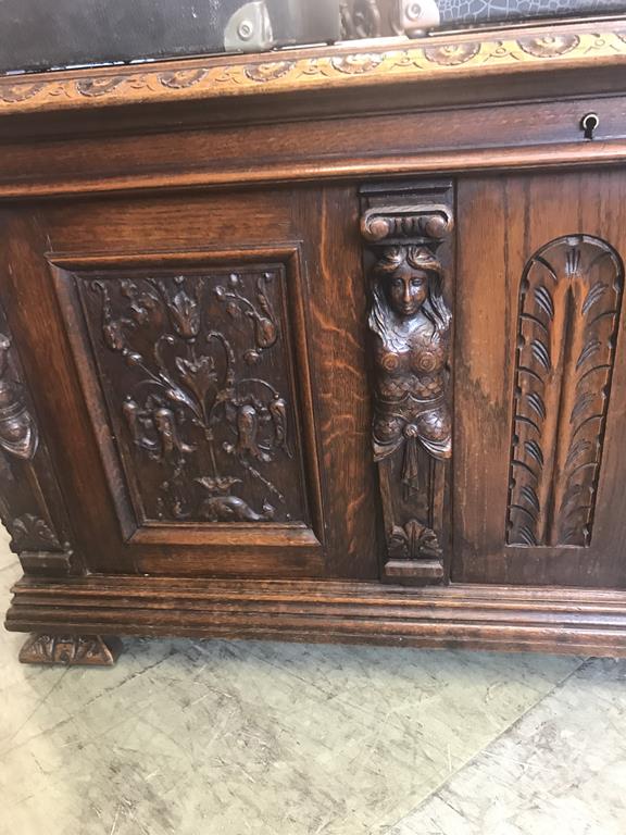 A heavily carved oak chest with moulded edge, below four caryatids, with carved panels and feet, - Image 2 of 2