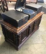 A heavily carved oak chest with moulded edge, below four caryatids, with carved panels and feet,