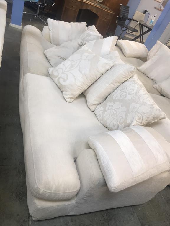 A large four seater cream settee (all covers removable and washable)