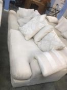 A large four seater cream settee (all covers removable and washable)