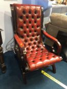 A burgundy Chesterfield button back armchair