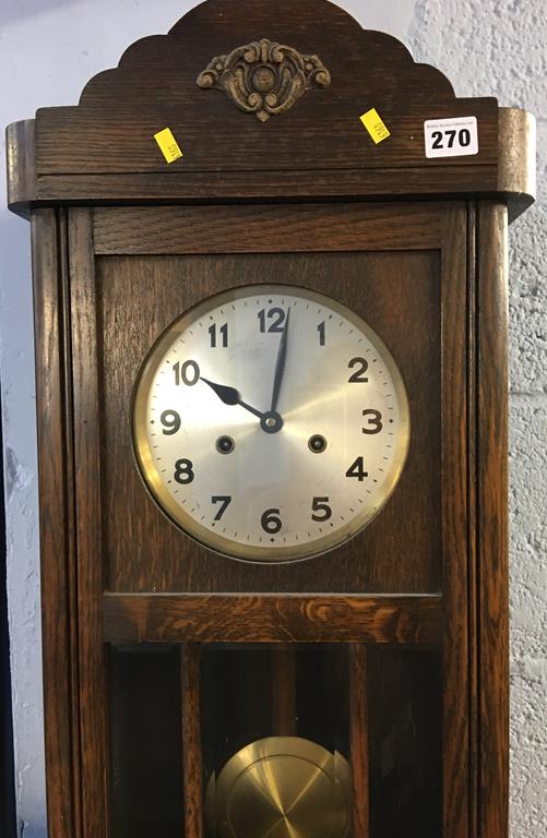 An oak cased wall clock