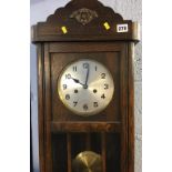 An oak cased wall clock