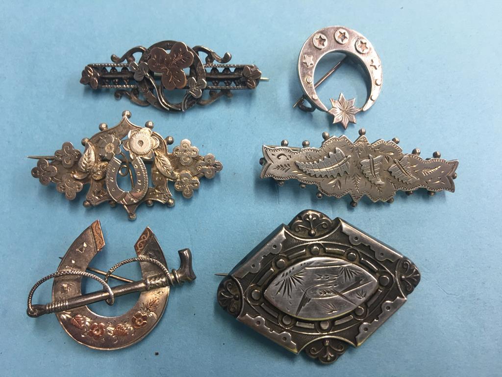 Six silver brooches