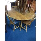 An Ercol Golden Dawn table and four Ercol spindle back chairs