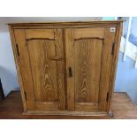 A small pine two door cabinet