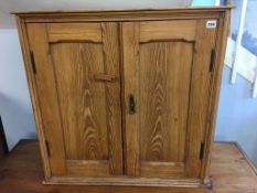 A small pine two door cabinet