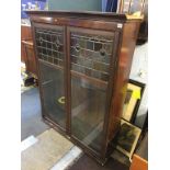 A bookcase top, with part leaded glass door