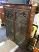 A bookcase top, with part leaded glass door