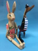 An articulated rabbit and a wooden pirate duck