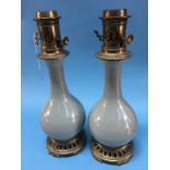 A pair of Chinese Celadon porcelain oil lamps, with brass mounts