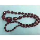 A faceted red amber coloured necklace