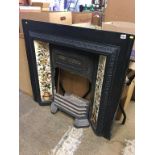 A Victorian cast iron fire surround, with tile inset and grate