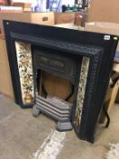 A Victorian cast iron fire surround, with tile inset and grate