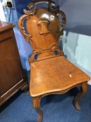 A Victorian oak hall chair