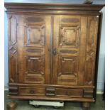 A large oak French Armoire with moulded cornice, two panelled doors, below two short drawers,