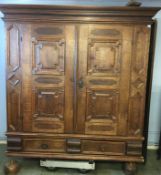 A large oak French Armoire with moulded cornice, two panelled doors, below two short drawers,