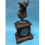 A mantle clock, mounted with a spelter bust of Apollo