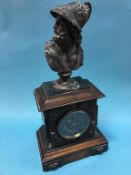 A mantle clock, mounted with a spelter bust of Apollo