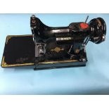 A Singer 22IKI sewing machine, with case and accessories
