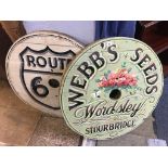 Two painted circular pine signs