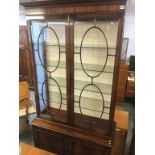 A reproduction mahogany display cabinet