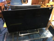 A Sony 49" TV (with remote in office)