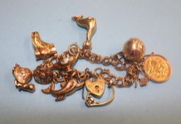 A 9ct bracelet with various gold charms, including a mounted half Sovereign etc., 32.5 grams