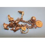 A 9ct bracelet with various gold charms, including a mounted half Sovereign etc., 32.5 grams