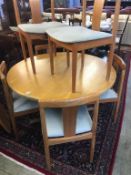 A Danish teak circular table and six chairs