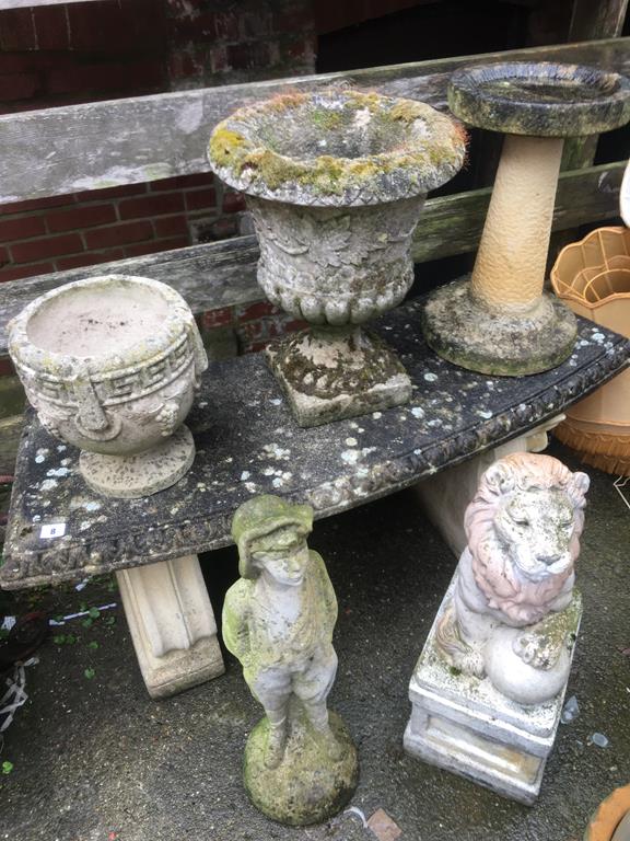A garden bench, urns and various figures