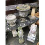 A garden bench, urns and various figures