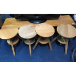 An oak bench and four swivel top stools